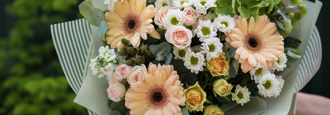 Peach and cream hand-tied bouquet with gerberas and roses