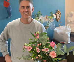 Simon with fresh flower arrangement