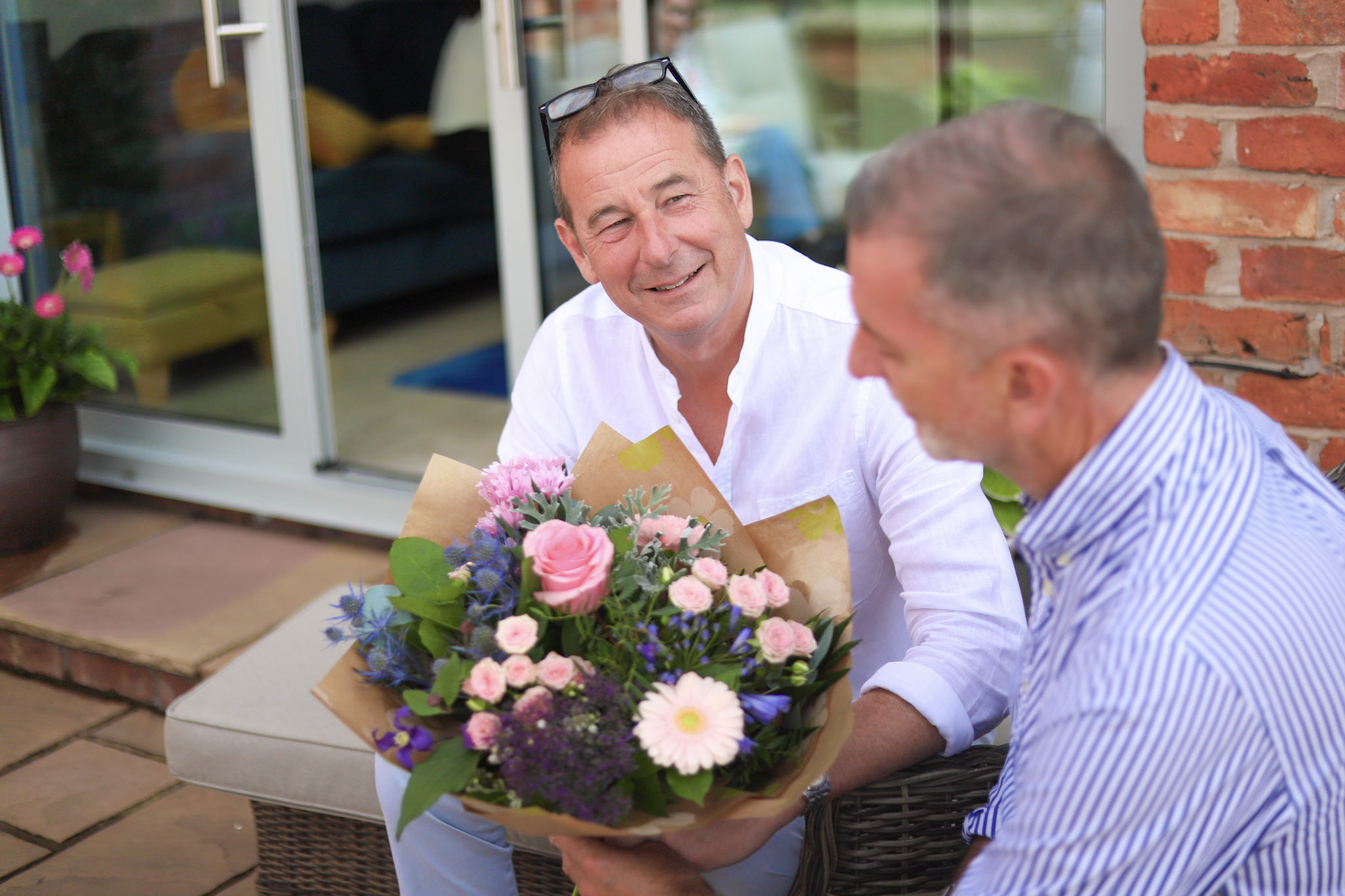 Two men admiring flowers delivered the same day by local florist