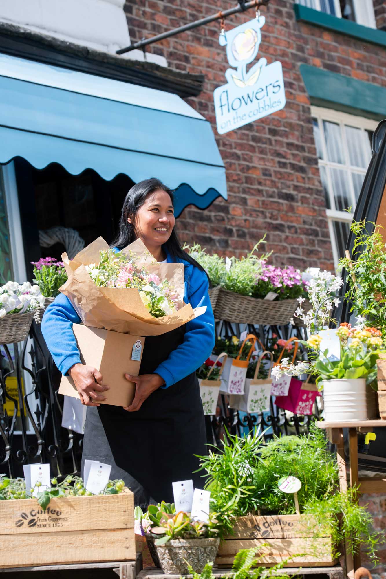 Smiling florist crafting seasonal bouquet, ready for fast delivery across Ireland