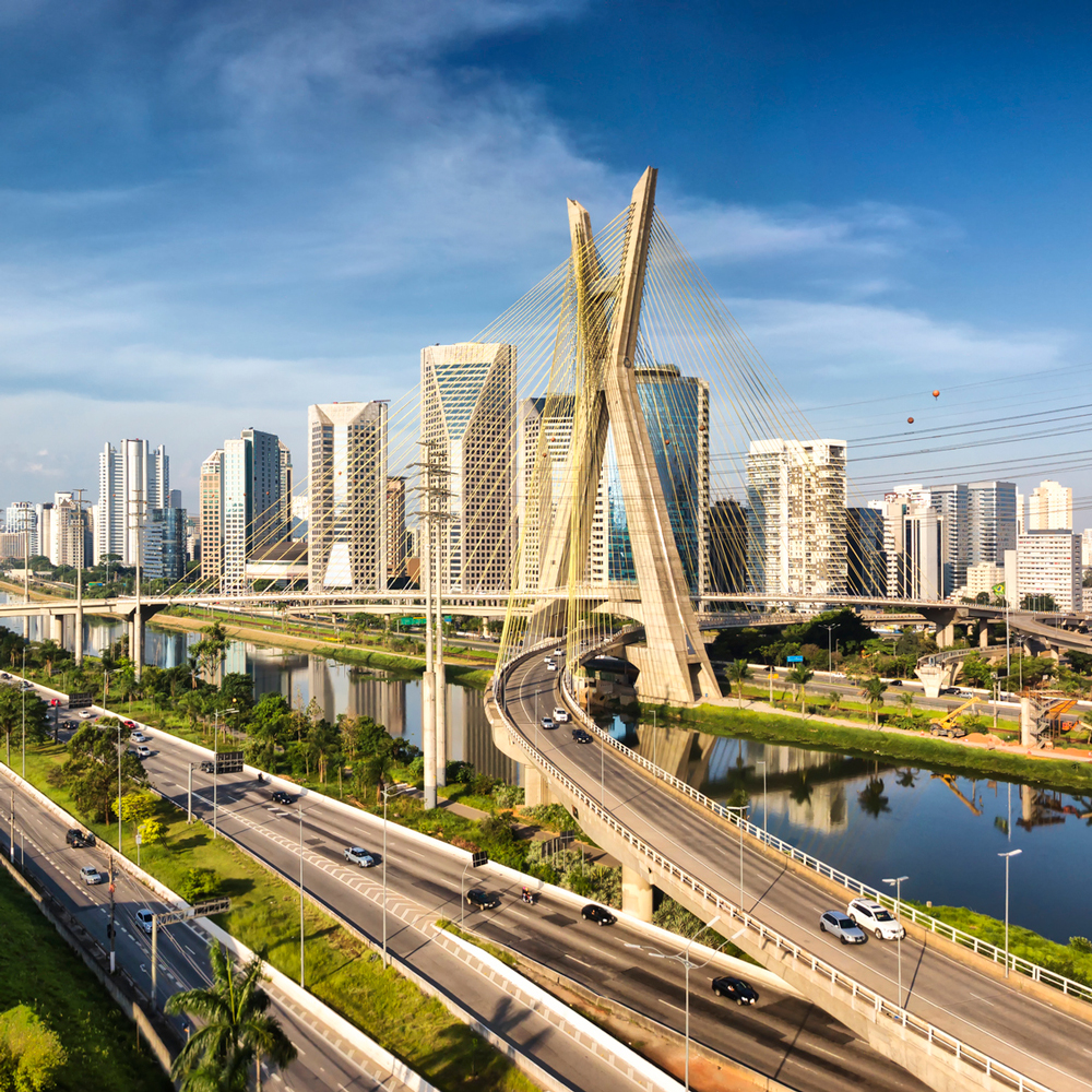 São Paulo cityscape with modern skyscrapers and Octávio Frias de Oliveira Bridge.