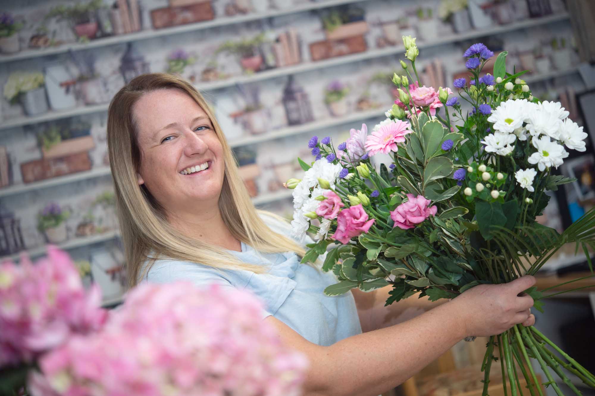 Smiling florist arranging a fresh bouquet