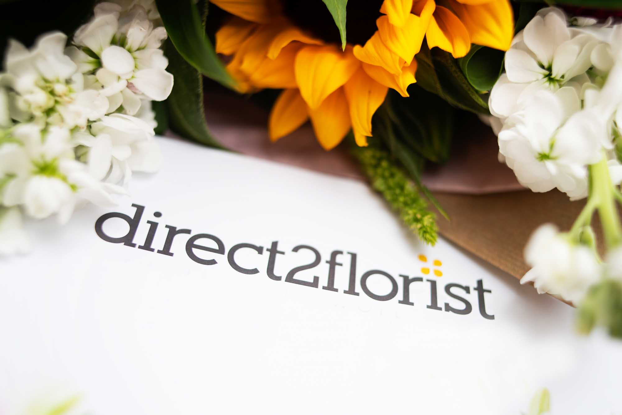 Close-up of Direct2Florist selection guide on florist's workbench
