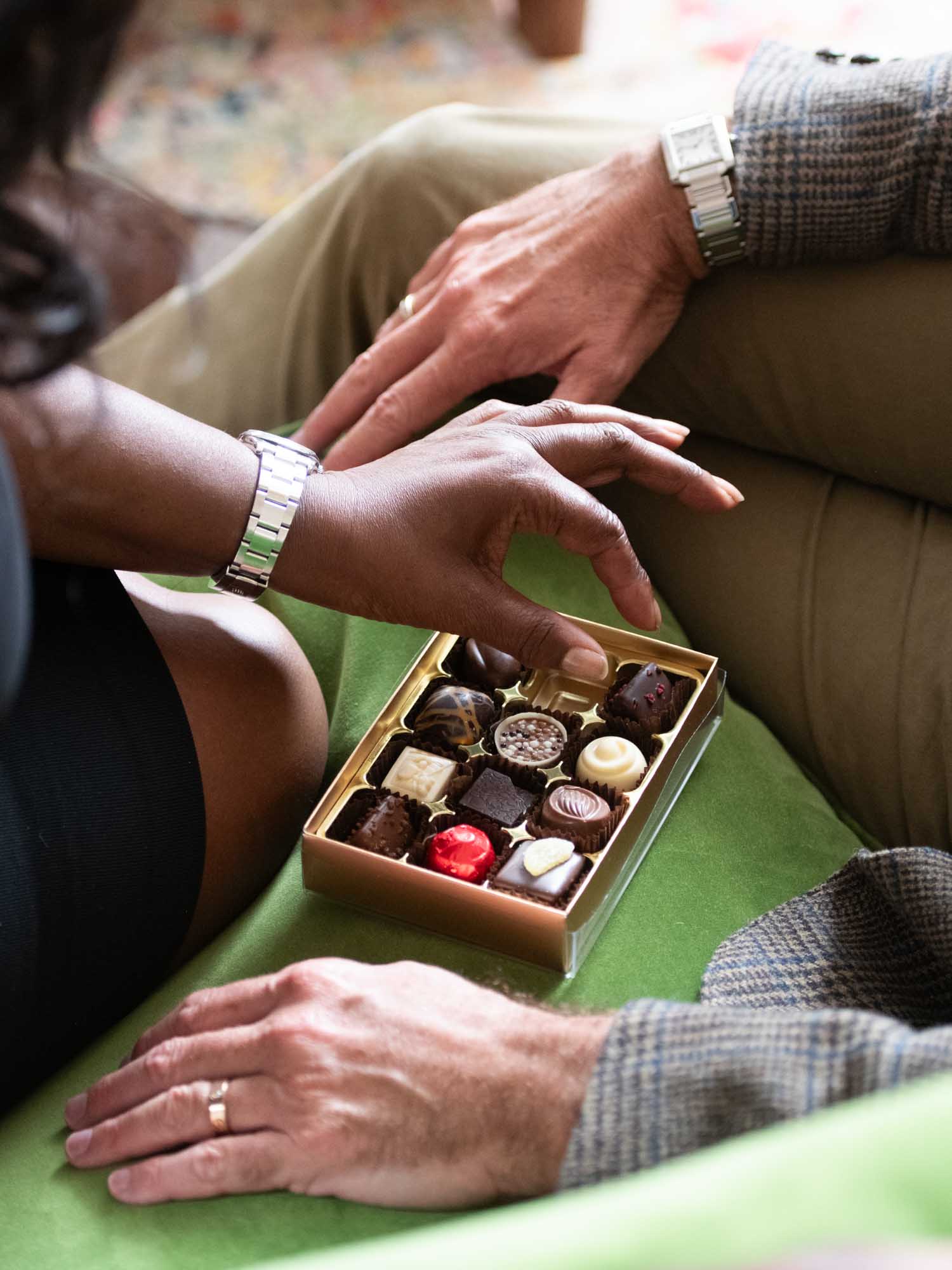 Two people enjoying luxury chocolates together as a gift