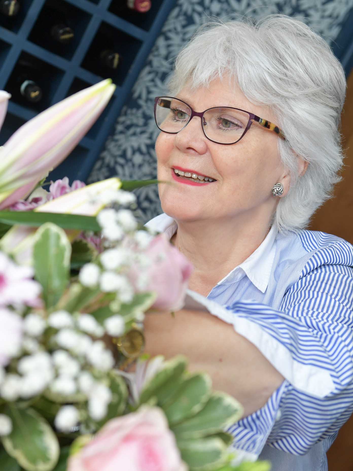 Woman holding winter flowers arranged by local florist