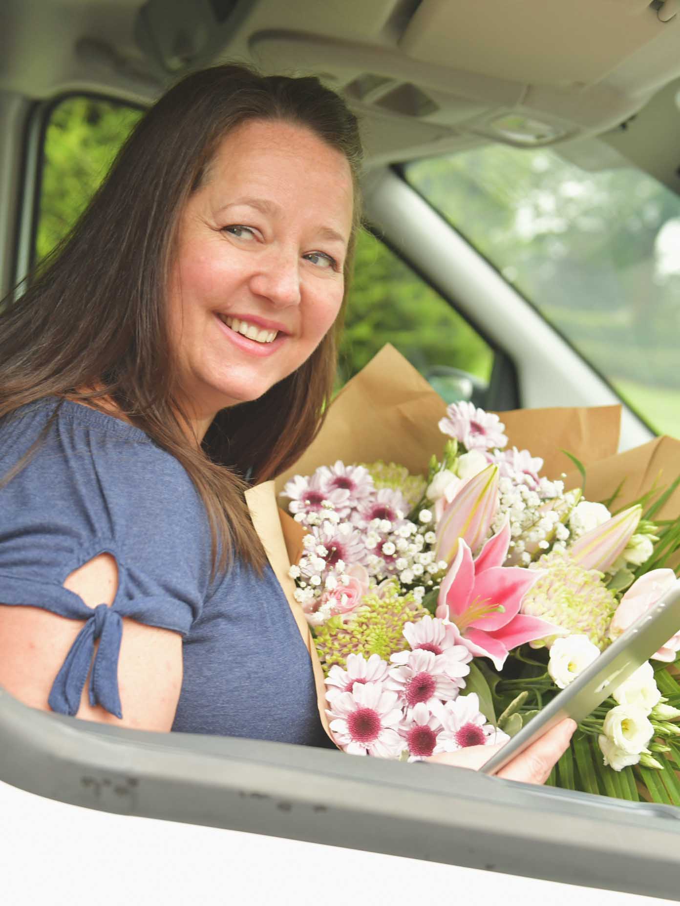 Smiling florist ready to make next flower delivery