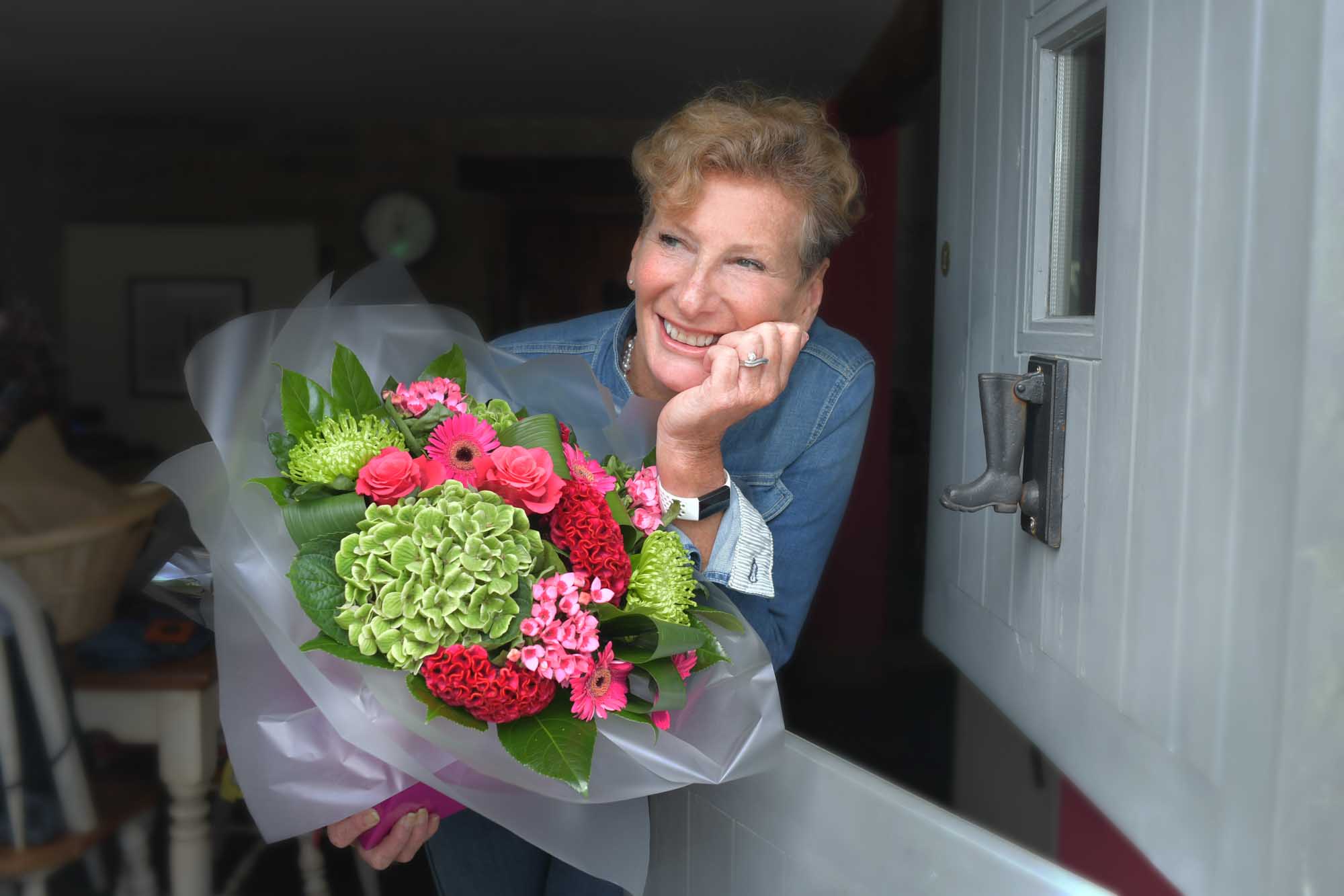 Smiling woman with same day flower delivery