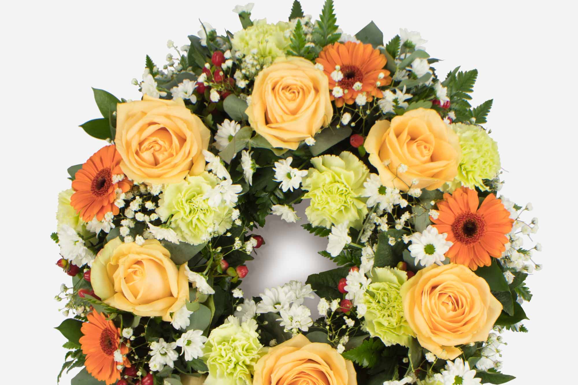 Close-up of a peach and orange-themed funeral wreath on a white background.