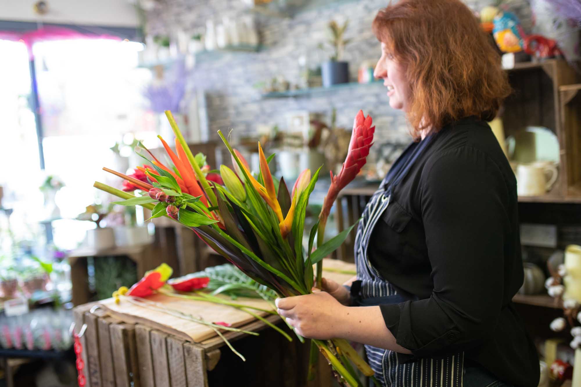 Florist arranges tropical long lasting flowers ready for delivery to an Irish office or workplace