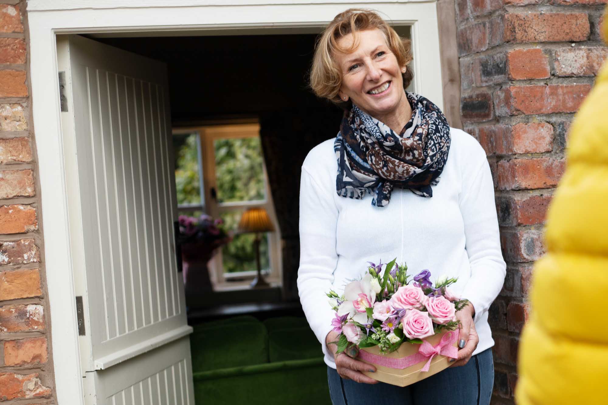 Woman with luxury bouquet arrangement from local florist