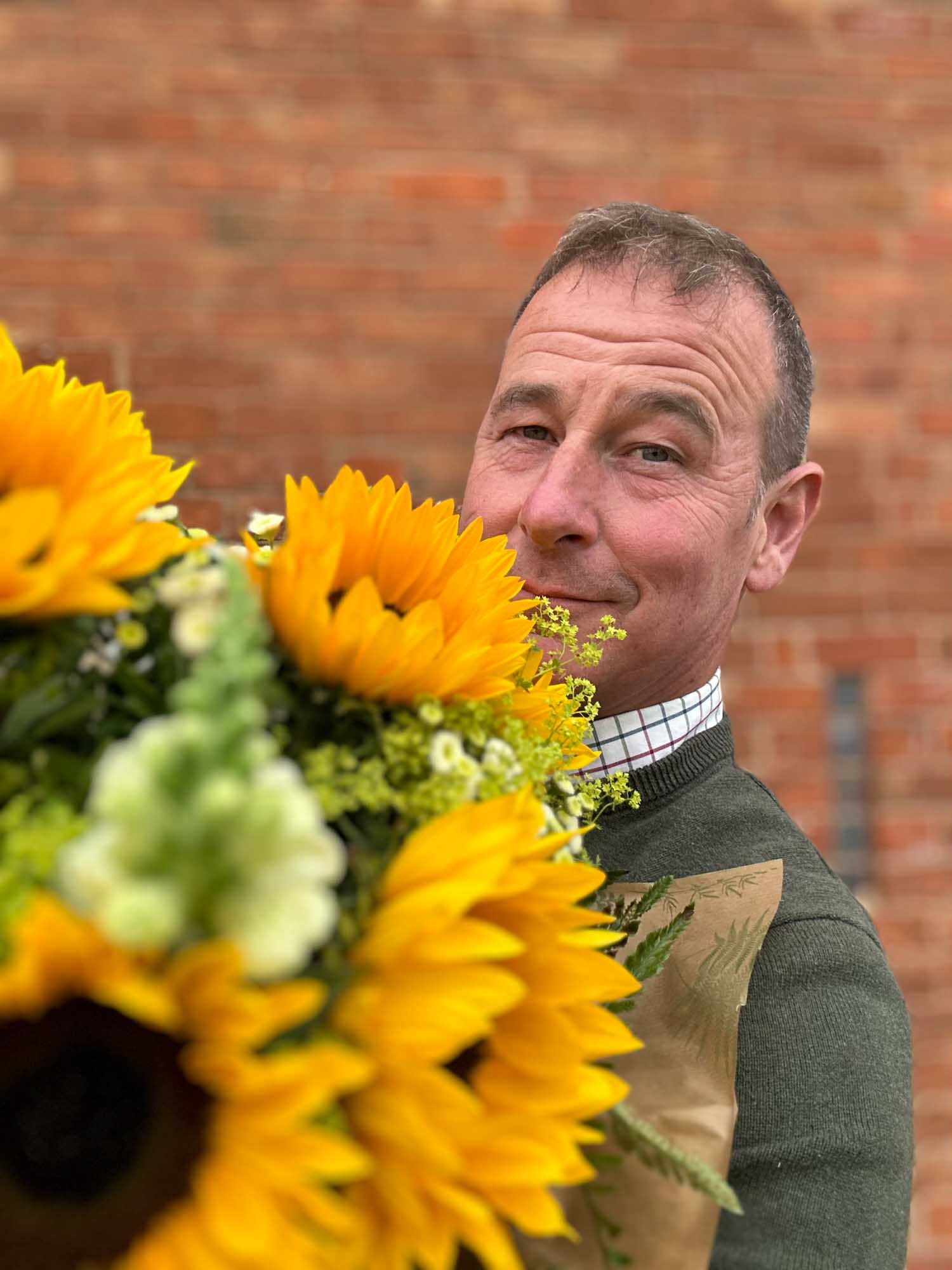 Man receiving flowers from partner